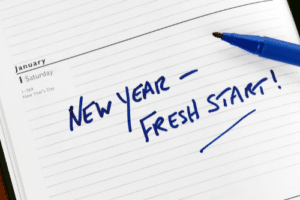 The Top 4 New Year's Tax Resolutions for Small Businesses in Hammond La with Sensible Services ABC; image of New Year- Fresh Start written in blue marker, underlined in planner with tip of marker showing