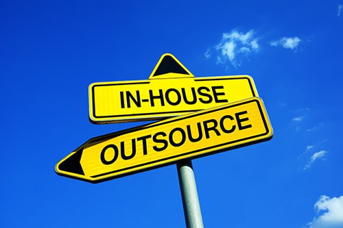Traffic sign with two options: outsource or in-house. Concept image of “In-House vs. Outsourced: A Look at Bookkeeping and Accounting Services| | Sensible Services ABC in Hammond, LA.